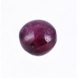 † An unmounted circular cabochon star ruby