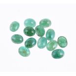 † A packet of oval cabochon emeralds