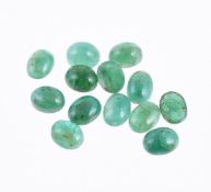 † A packet of oval cabochon emeralds