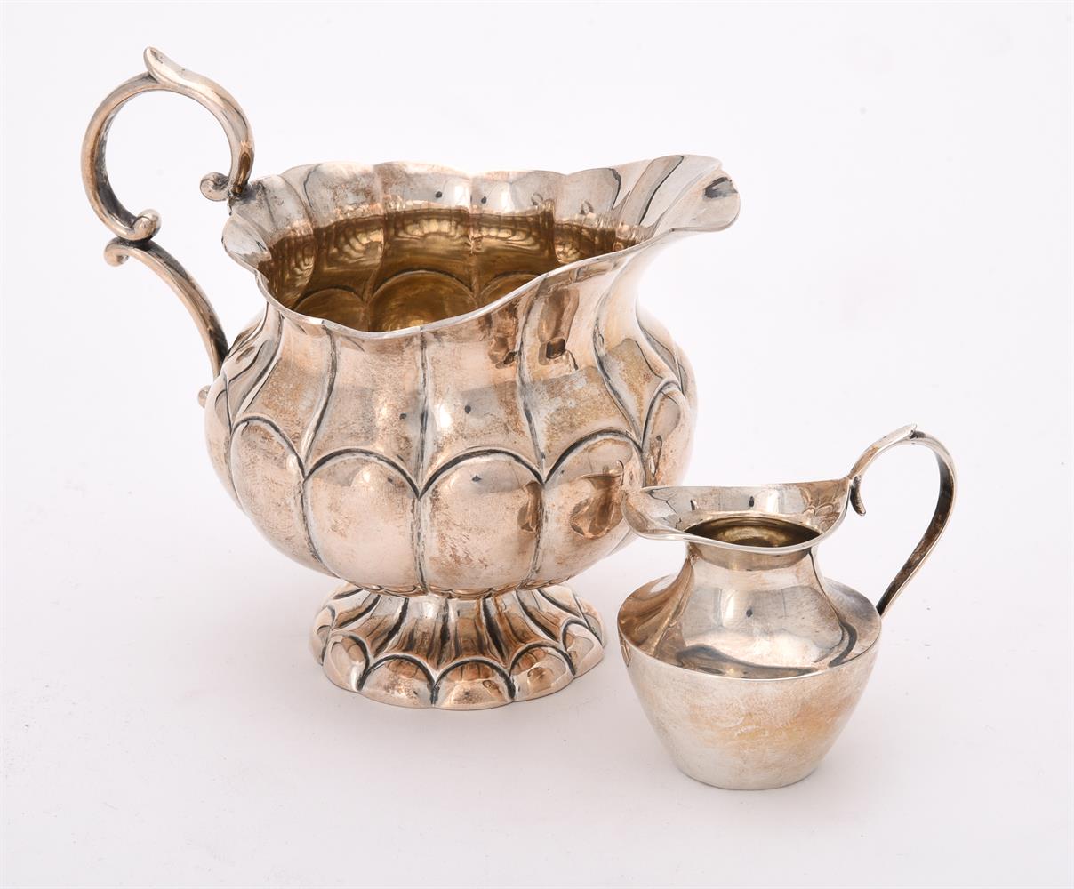 A continental silver coloured lobed cream jug