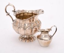 A continental silver coloured lobed cream jug