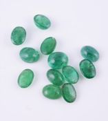 † A parcel of oval cabochon emeralds