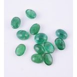 † A parcel of oval cabochon emeralds