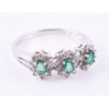 An emerald and diamond triple cluster ring