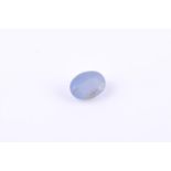 † An unmounted oval cabochon star sapphire