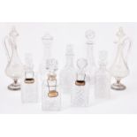 A collection of nine cut glass decanters