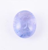 † An unmounted oval cabochon sapphire