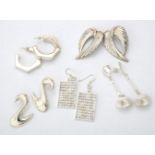 A collection of silver and silver coloured earrings