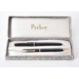 A collection of black Parker pens