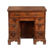 A George II walnut and feather banded kneehole desk