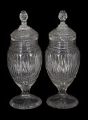 A pair of Continental cut-glass pedestal urns and covers with facetted ball stoppers