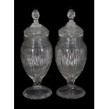 A pair of Continental cut-glass pedestal urns and covers with facetted ball stoppers