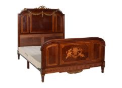 A French mahogany and marquetry bedhead and foot with gilt metal mounts