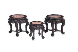 A pair of Chinese of carved hardwood and marble inset low tables or stands