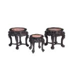 A pair of Chinese of carved hardwood and marble inset low tables or stands