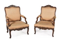 A pair of carved beech fauteuils a le reine in Louis XV French Provincial style