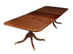 A mahogany twin pedestal D-end dining table