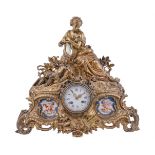 A French giltmetal and Sevres-style porcelain inset mantel clock