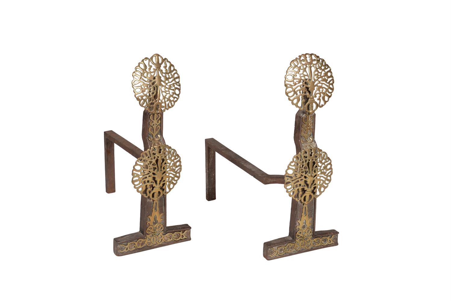 A pair of Arts and Crafts cast iron and brass mounted andirons