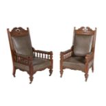 A pair of Victorian carved oak and upholstered armchairs