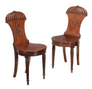 A pair of George IV mahogany hall chairs