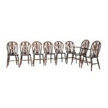 A set of eight beech and elm wheel back dining chairs