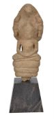 A Khmer sandstone figure of Buddha sheltered by the seven headed cobra Mucalinda