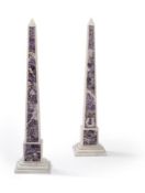 A pair of amethyst marble inlaid obelisks
