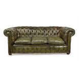 A green leather upholstered sofa