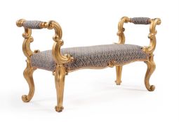 A carved giltwood window seat