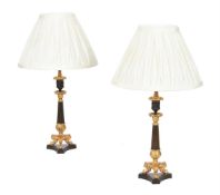 A pair of French gilt and patinated metal candlestick table lamps in Louis Philippe taste