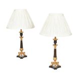 A pair of French gilt and patinated metal candlestick table lamps in Louis Philippe taste