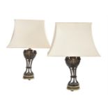 A pair of patinated, parcel gilt metal and green onyx mounted table lamps