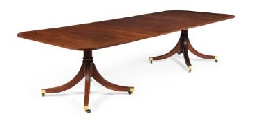 A mahogany and line inlaid twin pedestal dining table
