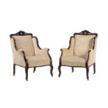 A pair of late Victorian mahogany and upholstered armchairs