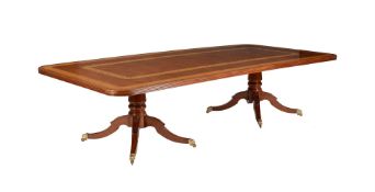 Y A mahogany and satinwood crossbanded twin pedestal dining table by Restall