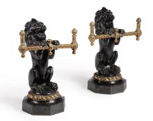 A pair of Victorian cast iron and brass fire dogs