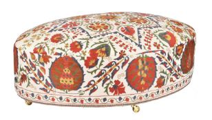 An oval Susani upholstered centre stool