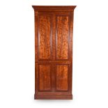 A GEORGE IV 'PLUM PUDDING' MAHOGANY HALL CUPBOARD, CIRCA 1825