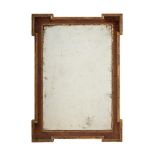 A GEORGE II WALNUT AND PARCEL GILT WALL MIRROR, IN THE MANNER OF WILLIAM KENT