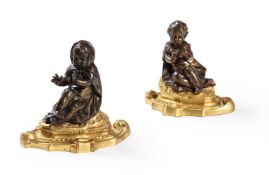 A PAIR OF LOUIS XV PATINATED AND GILT BRONZE PRESSE-PAPIERS, CIRCA 1760