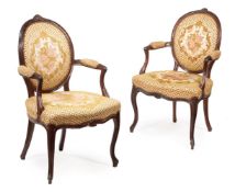 A SET OF EIGHT GEORGE III MAHOGANY AND UPHOLSTERED OPEN ARMCHAIRS, CIRCA 1770