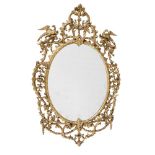 A CARVED GILTWOOD OVAL WALL MIRROR, IN GEORGE III STYLE, SECOND HALF 19TH CENTURY
