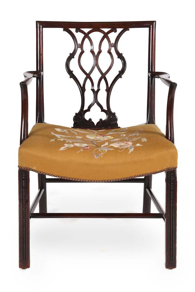 A GEORGE III MAHOGANY AND UPHOLSTERED OPEN ARMCHAIR, IN THE MANNER OF THOMAS CHIPPENDALE, CIRCA 1775