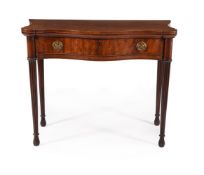 A GEORGE III MAHOGANY SERPENTINE FOLDING CARD TABLE, IN THE MANNER OF INCE & MAYHEW, CIRCA 1800