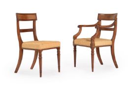 A SET OF TWELVE REGENCY MAHOGANY AND UPHOLSTERED DINING CHAIRS IN THE MANNER OF GILLOWS