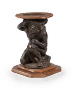 A CARVED WALNUT AND EBONISED FIGURAL TORCHERE STAND, MID 19TH CENTURY