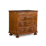 A WILLIAM III WALNUT, FEATHER BANDED AND LINE INLAID CHEST OF DRAWERS, CIRCA 1700