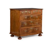 A WILLIAM III WALNUT, FEATHER BANDED AND LINE INLAID CHEST OF DRAWERS, CIRCA 1700