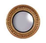 A REGENCY GILTWOOD CIRCULAR CONVEX WALL MIRROR, CIRCA 1820